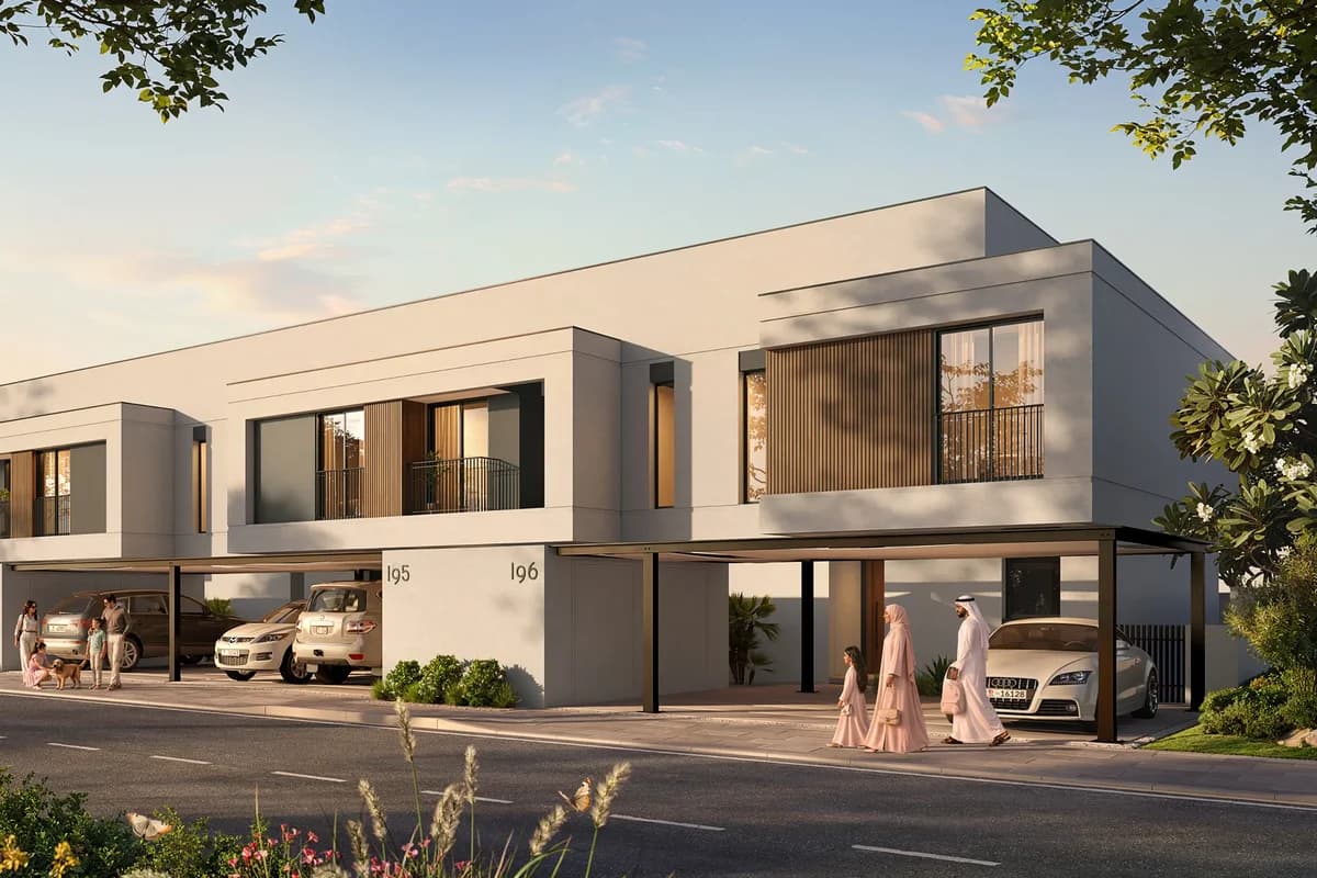 Night exterior of Al Ghadeer Gardens townhouses with landscaped pedestrian streets