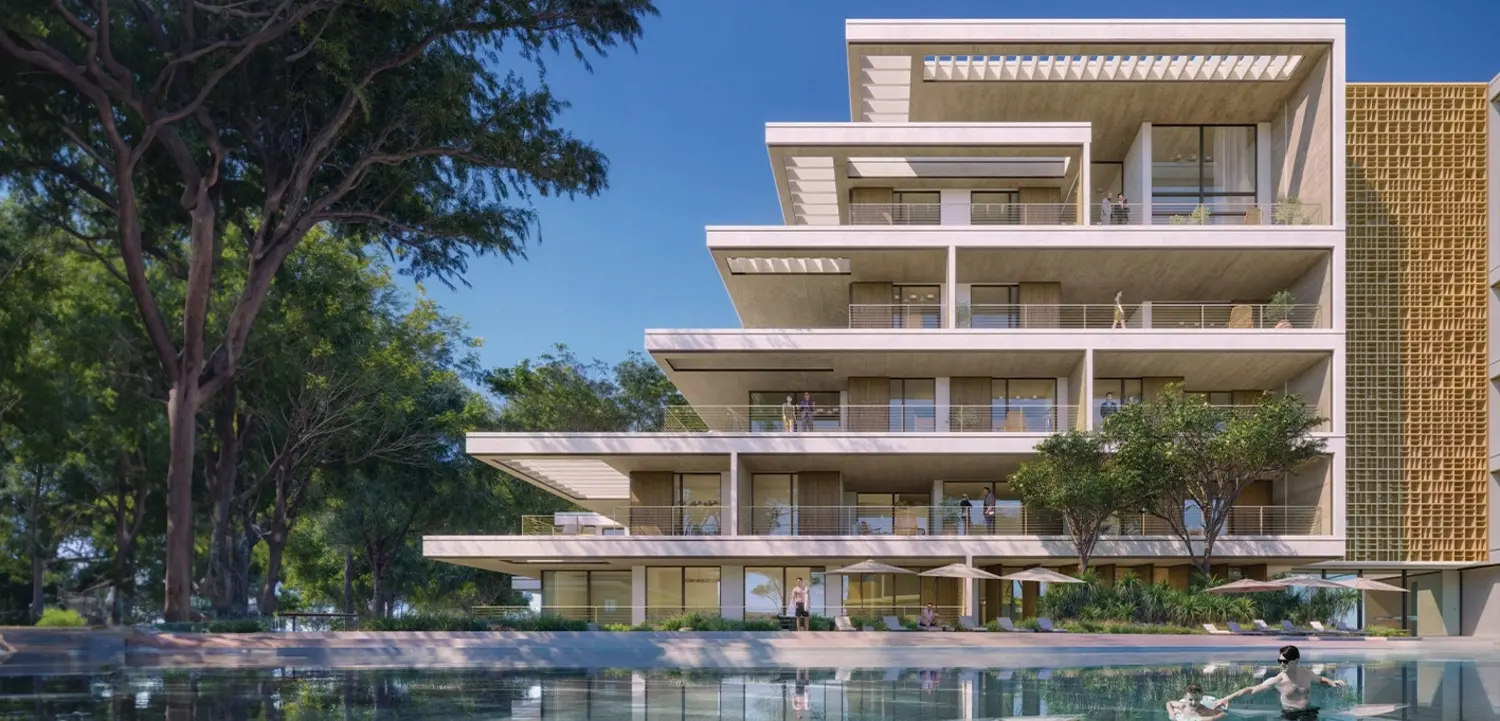 Naseem Al Jurf apartment building beside a landscaped pool in the AlJurf canal community