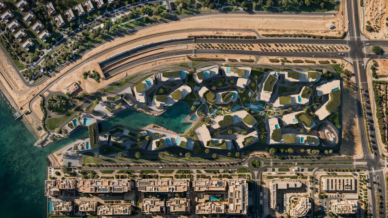 Overhead master plan of The Wadi on the Yas Canal in Abu Dhabi, showing the two residential buildings, central green valley, and canal basin