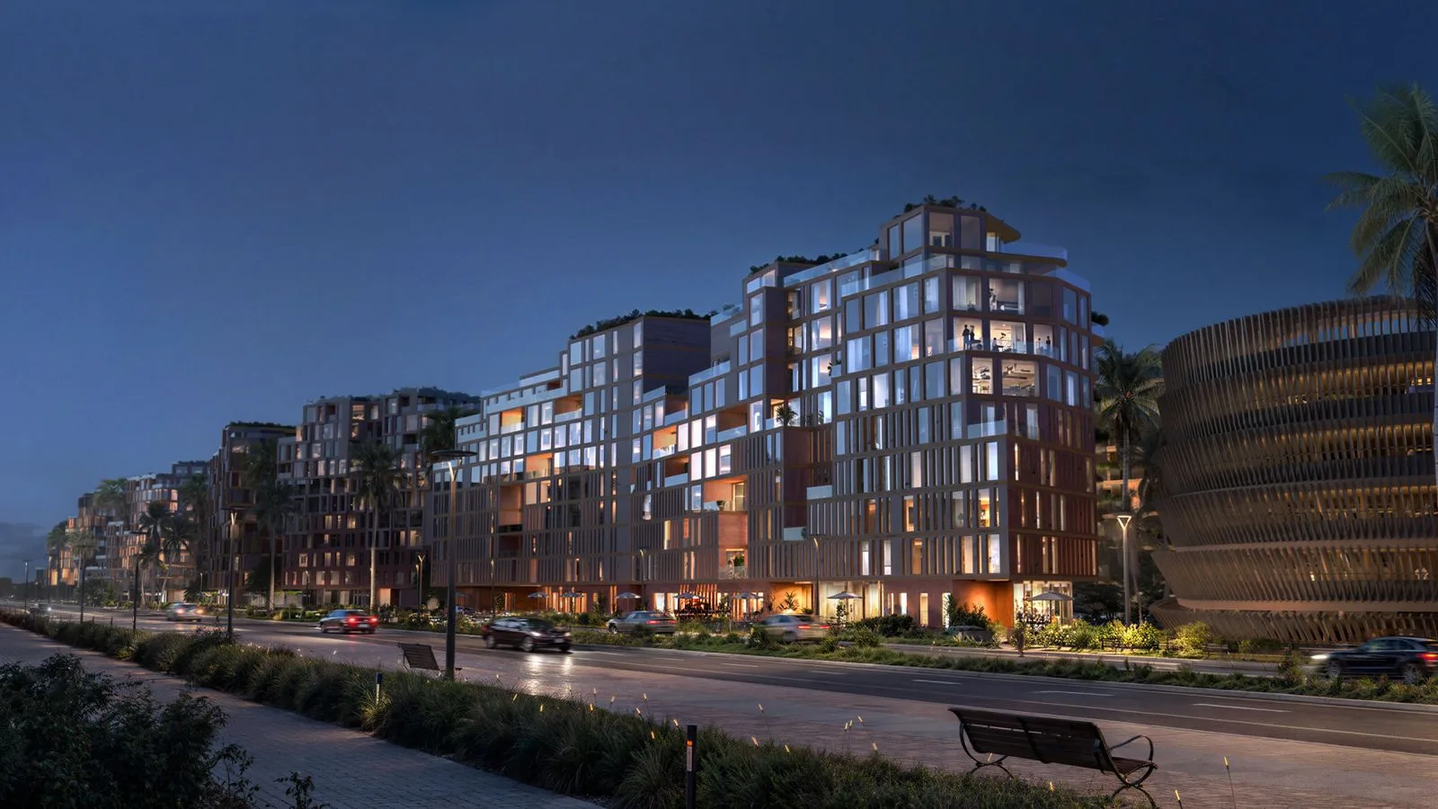 Evening street view of a lit The Wadi apartment building on the Yas Canal in Abu Dhabi