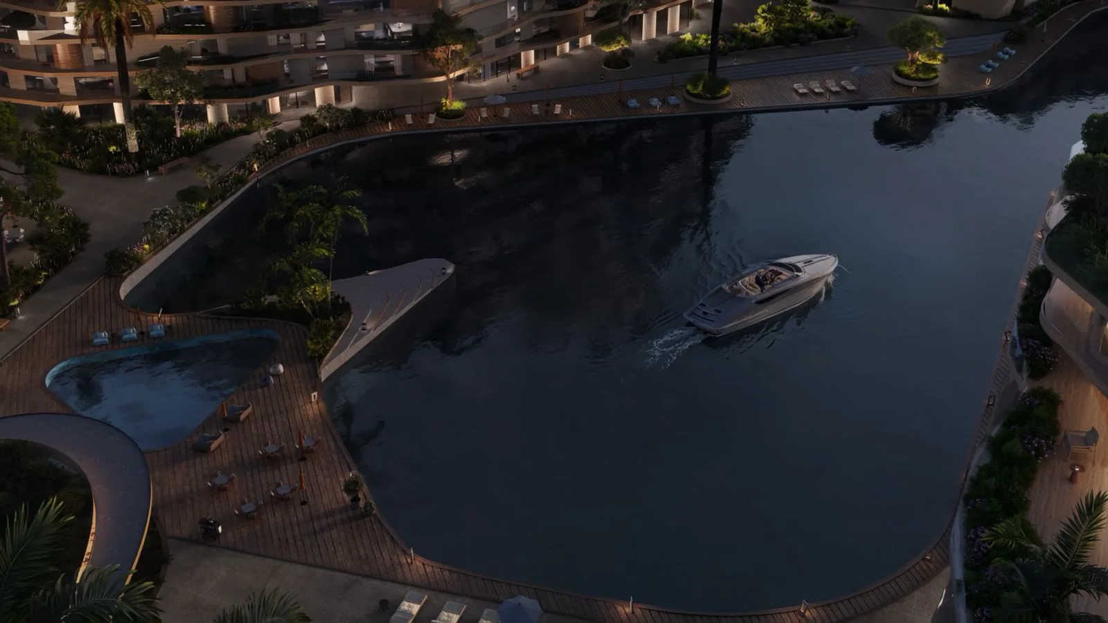 Evening view of a yacht in the canal basin beside The Wadi residences on the Yas Canal in Abu Dhabi
