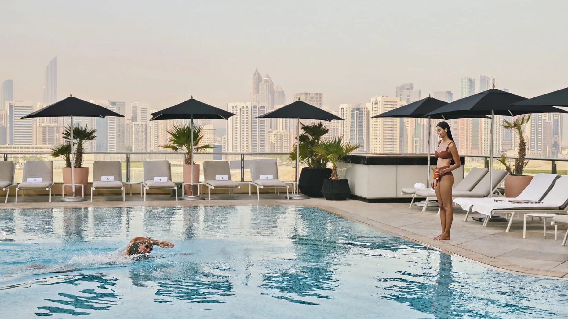 Outdoor pool deck overlooking the Abu Dhabi skyline at Four Seasons Private Residences, Al Maryah Island