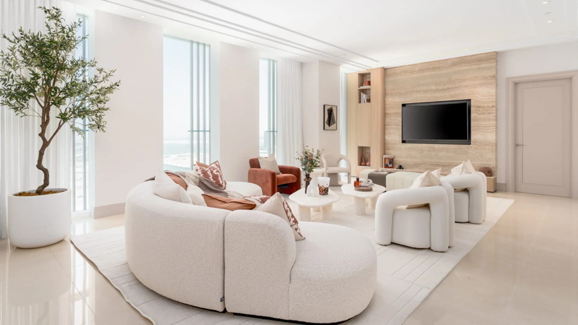 Living room with full-height glazing at Four Seasons Private Residences Abu Dhabi, Al Maryah Island