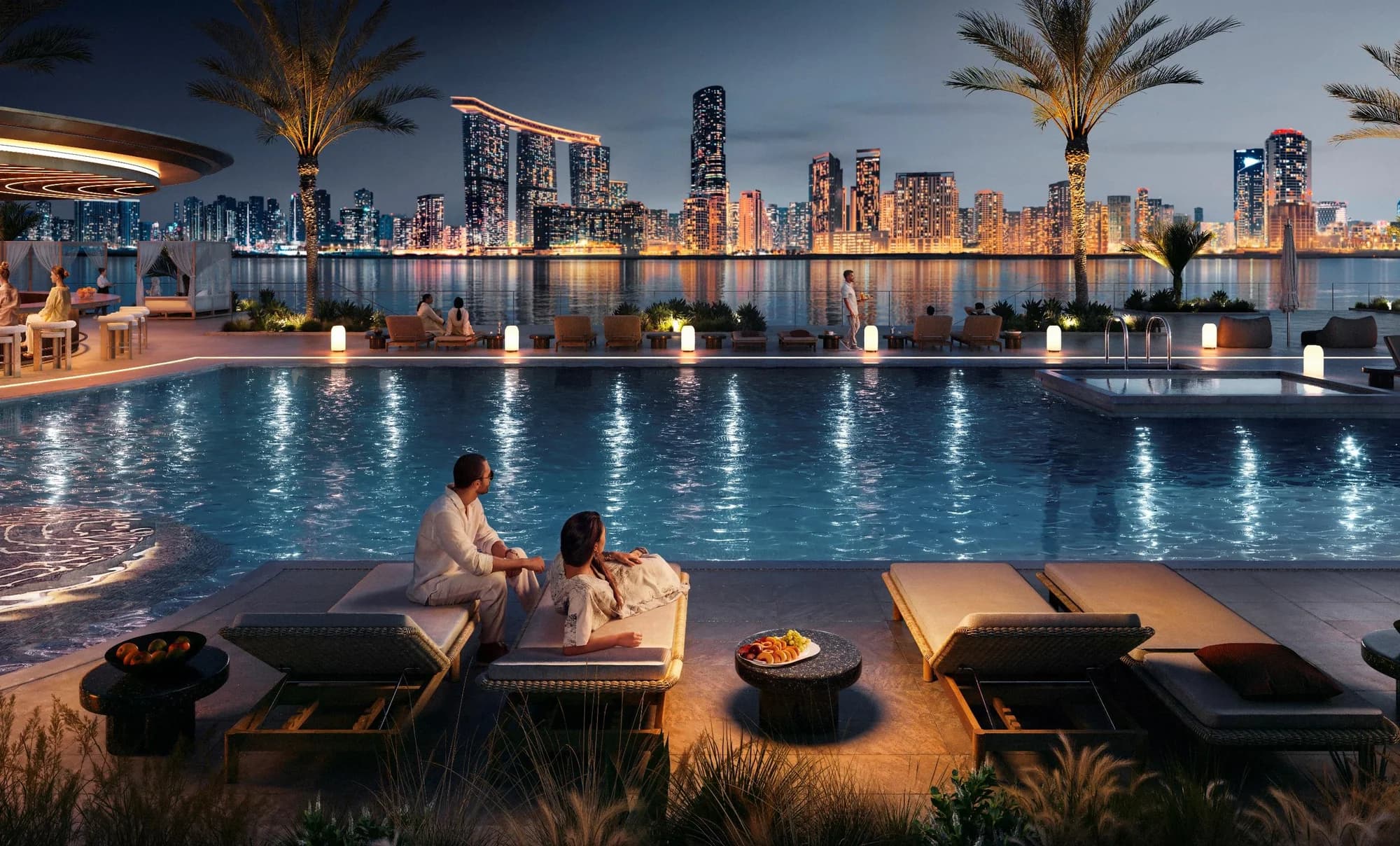 Night pool at Talay Beach, Marsa Al Saadiyat, with the lit Reem Island skyline across the water