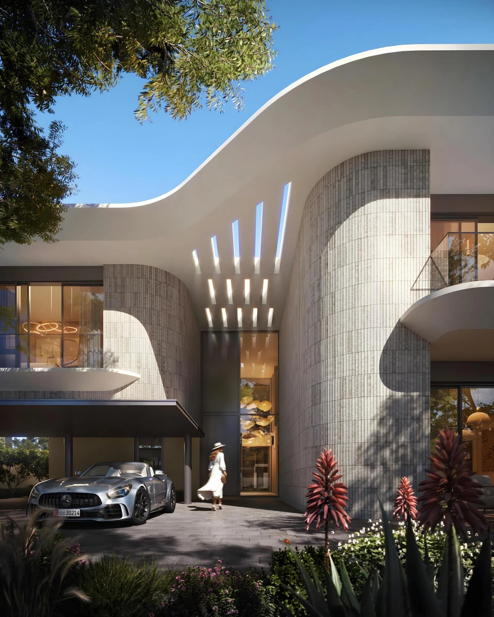 Talay villa entrance courtyard at Marsa Al Saadiyat, with a curved roofline and sculptural feature wall